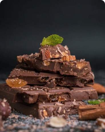 chocolate pieces with cinnamon, nuts and mint leaf